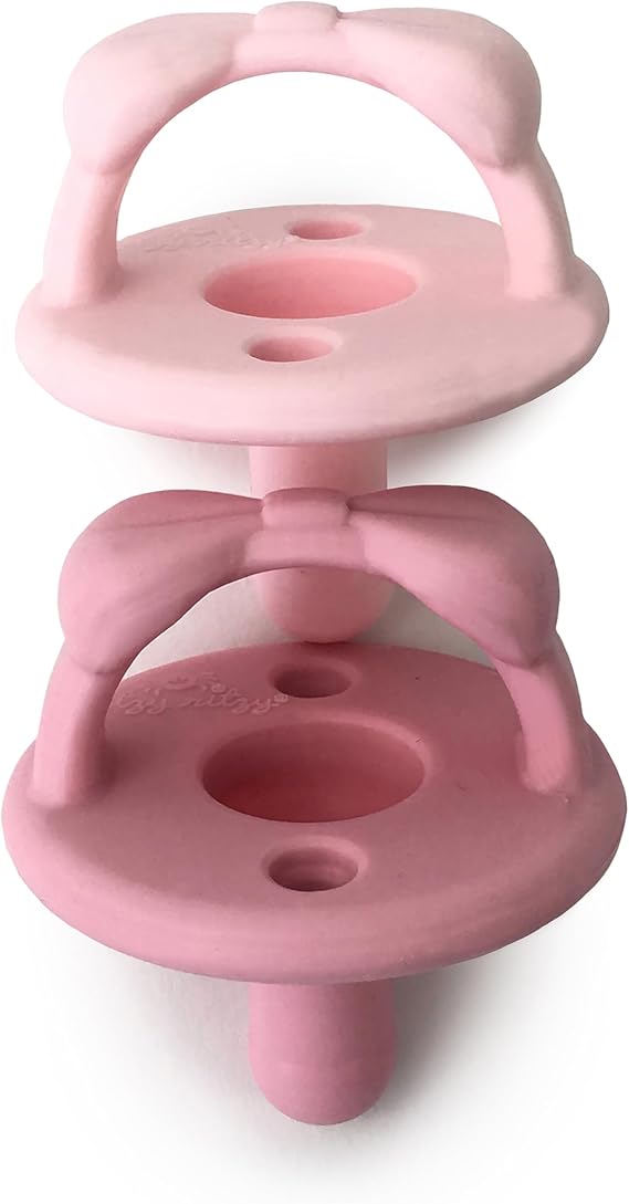 Itzy Ritzy Silicone Pacifier for ages 6-18 months - The Itzy Soother Pacifier features a foldable handle and two air holes for added safety. Light pink and dark pink, for ages 6-18 months